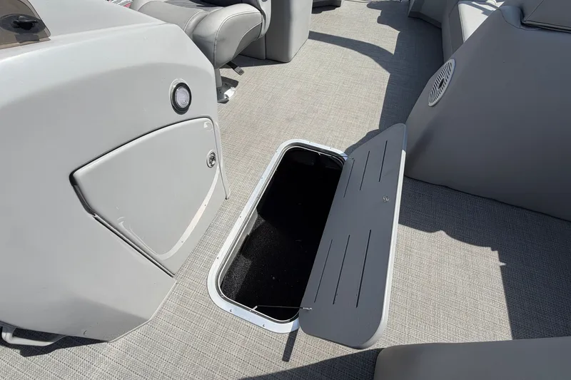 Slide: The Image of Open storage compartment on 2025 Bennington 22 L Quad Bench boat interior. - 42