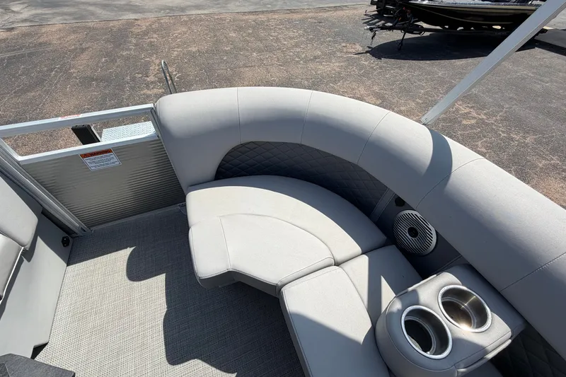 Slide: The Image of 2025 Bennington 22 L Quad Bench boat interior with curved seating and cup holders. - 17