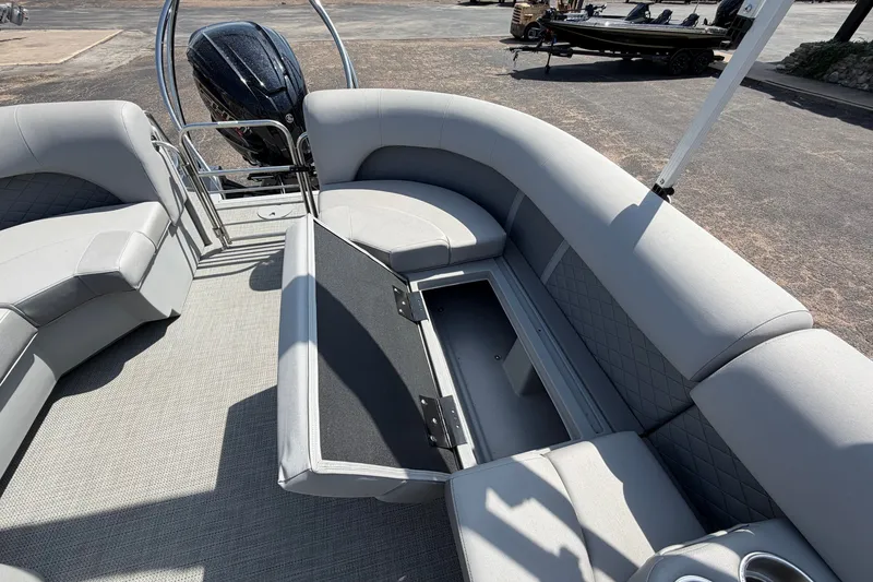 Slide: The Image of 2025 Bennington 22 L Quad Bench boat interior with open storage compartment. - 29