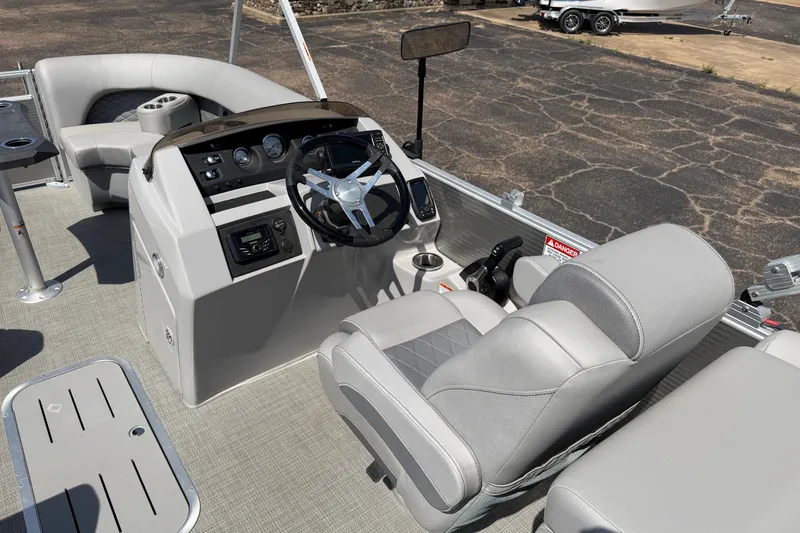 Slide: The Image of 2025 Bennington 22 L Quad Bench boat interior with modern helm and seating. - 39