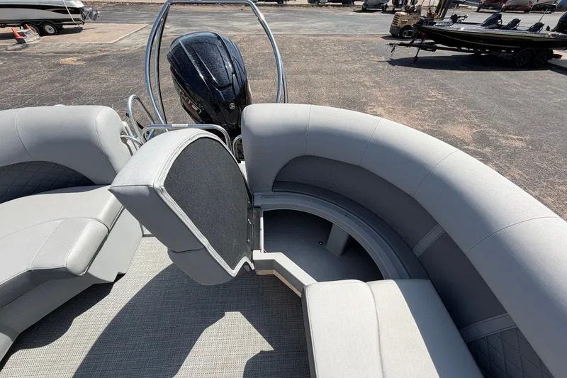Slide: The Image of 2025 Bennington 22 L Quad Bench boat interior with open storage compartment and motor view. - 31