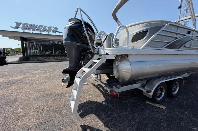 Slide: The Image of 2025 Bennington 22 L Quad Bench pontoon boat on trailer at dealership. - 12