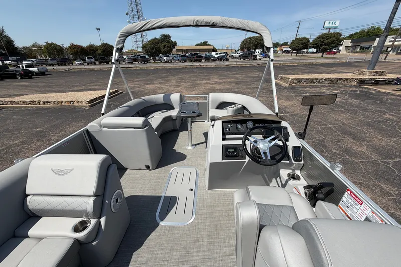 Slide: The Image of 2025 Bennington 22 L Quad Bench pontoon boat interior with modern seating and steering console. - 14