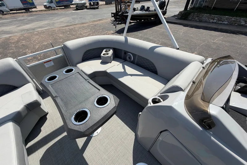 Slide: The Image of 2025 Bennington 22 L Quad Bench pontoon boat interior with seating and cup holders. - 16