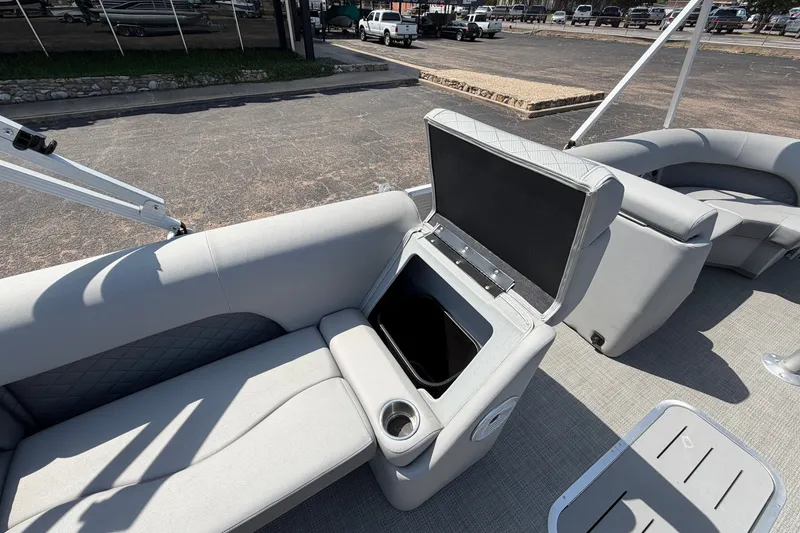 Slide: The Image of 2025 Bennington 22 L Quad Bench boat interior with open storage compartment. - 25