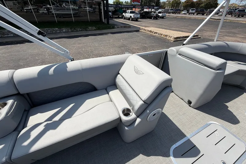 Slide: The Image of 2025 Bennington 22 L Quad Bench pontoon boat with luxurious seating and cup holders. - 24