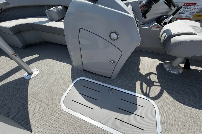 Slide: The Image of Interior of 2025 Bennington 22 L Quad Bench pontoon boat, featuring seating and helm area. - 43