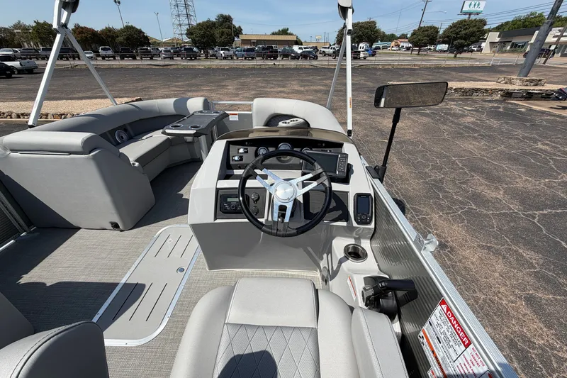 Slide: The Image of 2025 Bennington 22 L Quad Bench pontoon boat interior with steering console and seating. - 40