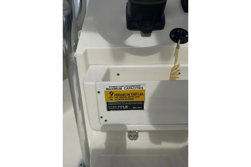 Slide: The Image of 2024 Key West 239 FS boat capacity label, maximum 9 persons or 1301 lbs. - 7