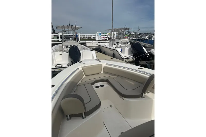 Slide: The Image of 2024 Key West 239 FS boat docked, showcasing spacious seating and sleek design. - 3