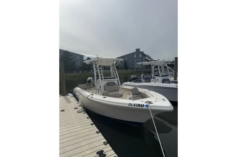The Image of 2024 Key West 239 FS boat docked at marina under cloudy sky. - 1