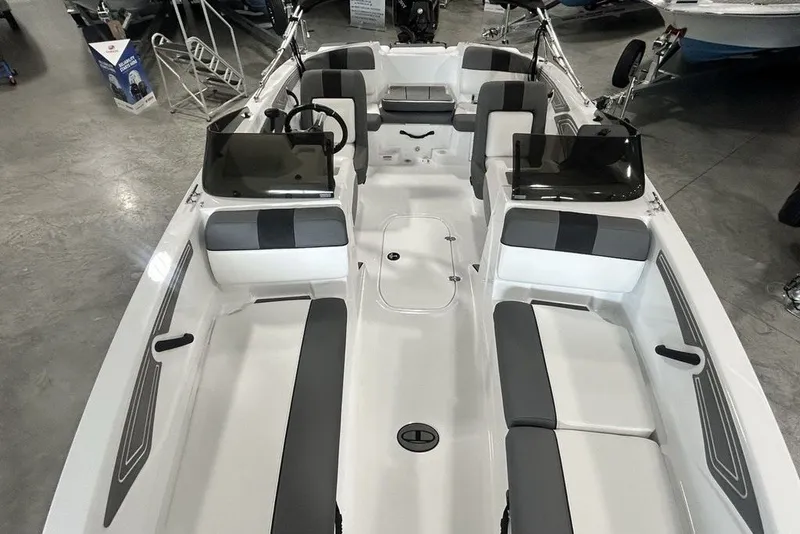 Slide: The Image of 2026 Tahoe T21 boat interior with sleek seating and modern design in a showroom. - 25