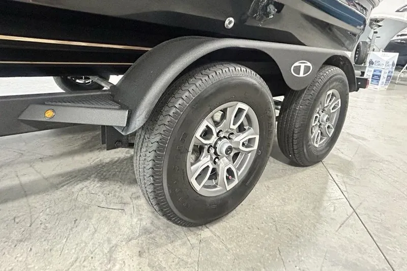 Slide: The Image of 2026 Tahoe T21 trailer wheels on a concrete floor, showcasing dual axle design. - 17