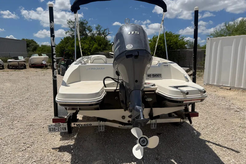 Slide: The Image of 2020 Stingray 182 SC boat with Yamaha 115 engine, parked on gravel lot. - 3