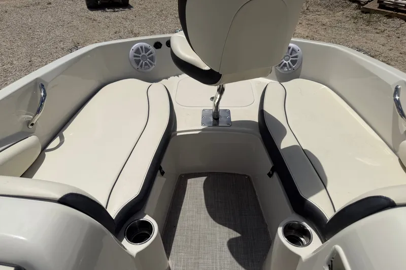 Slide: The Image of 2020 Stingray 182 SC boat interior with cushioned seating and cup holders. - 10