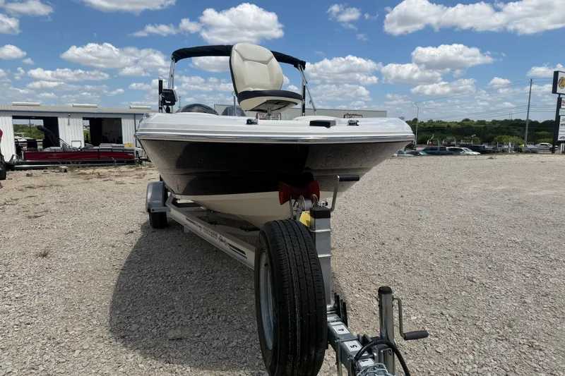 Slide: The Image of 2020 Stingray 182 SC boat on trailer under a clear blue sky. - 6