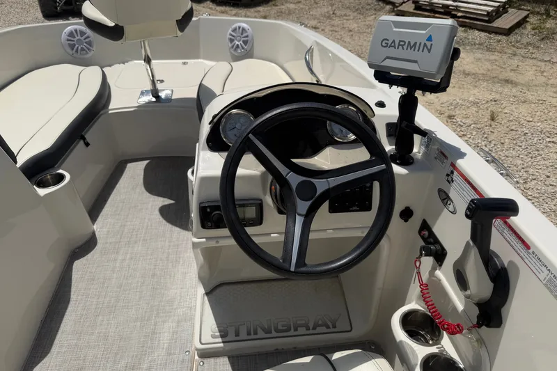 Slide: The Image of 2020 Stingray 182 SC boat interior with steering wheel and Garmin navigation system. - 9