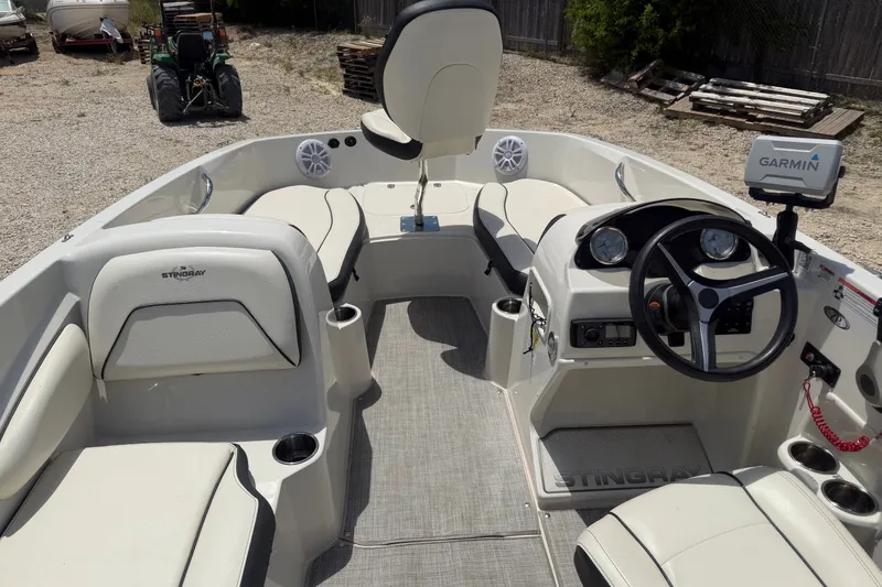Slide: The Image of 2020 Stingray 182 SC boat interior with steering wheel and Garmin navigation system. - 8