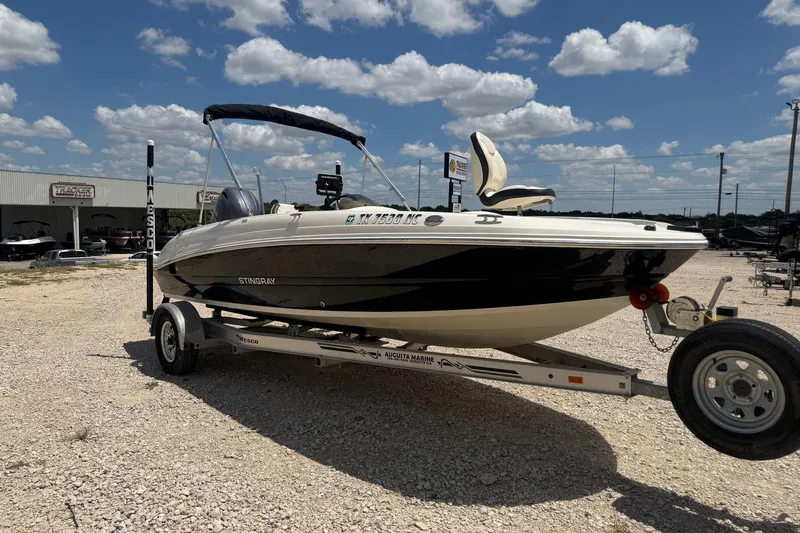 Slide: The Image of 2020 Stingray 182 SC boat on trailer under blue sky with clouds. - 5