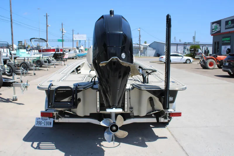 Slide: The Image of 2013 Blazer 675 Ultimate Bay boat with powerful outboard motor, parked in a dealership lot. - 18