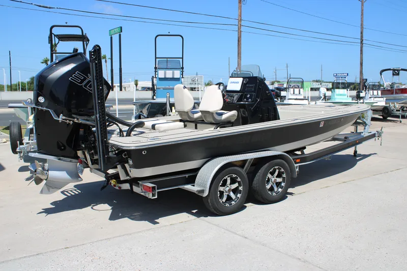 Slide: The Image of 2013 Blazer 675 Ultimate Bay boat on trailer, featuring powerful outboard motor. - 17