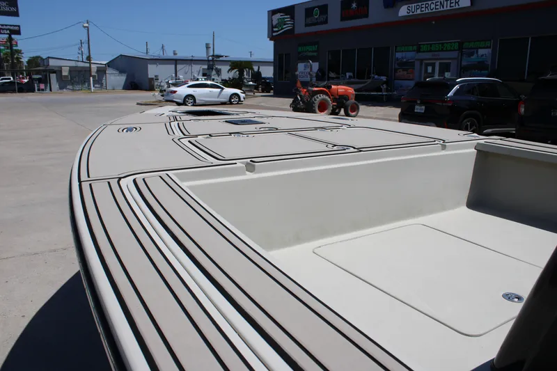 Slide: The Image of 2013 Blazer 675 Ultimate Bay boat displayed at a dealership with vehicles in the background. - 15