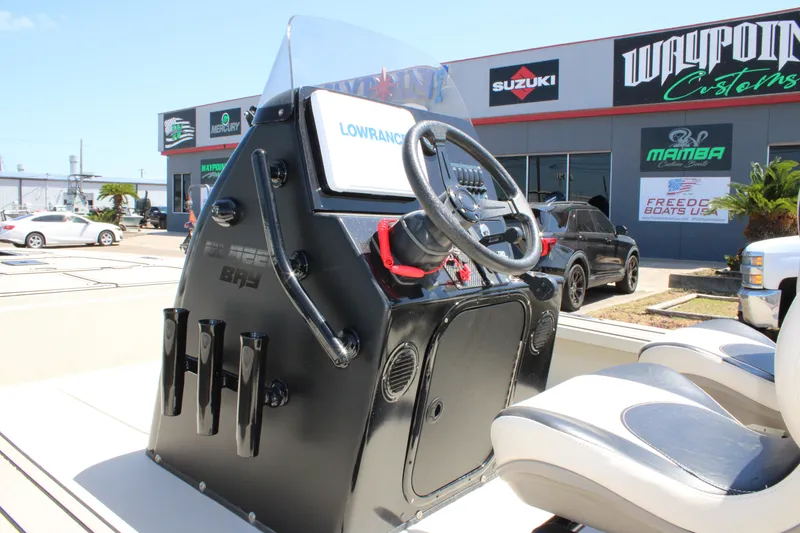 Slide: The Image of 2013 Blazer 675 Ultimate Bay boat console with steering wheel and Lowrance display. - 22