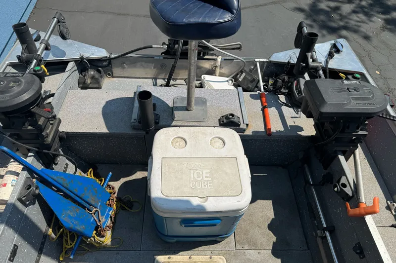 Slide: The Image of Interior of a 1995 Gregor Eagle 16 boat with fishing gear and cooler. - 16