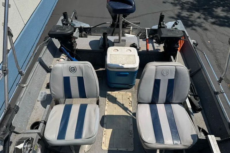 Slide: The Image of Interior of a 1995 Gregor Eagle 16 boat with seating and cooler. - 14