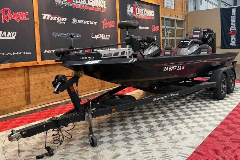 Slide: The Image of 2020 Ranger RT188P boat on trailer in showroom with branded banners. - 2