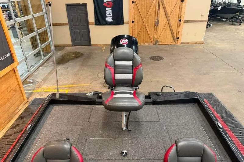 Slide: The Image of 2020 Ranger RT188P boat interior with gray and red seating in a showroom. - 4