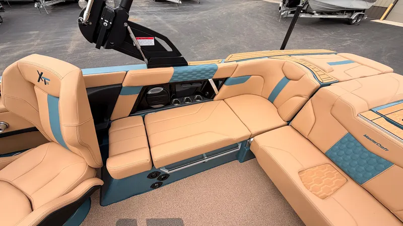 Slide: The Image of The image shows the interior of a 2027 MasterCraft XT22 with beige and blue seating. - 25