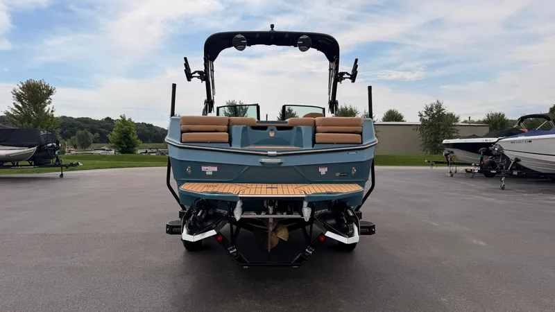 Slide: The Image of The image shows a 2027 MasterCraft XT22 boat parked on a lot. - 5