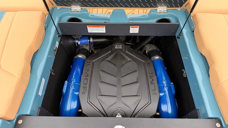 Slide: The Image of The engine compartment of a 2027 MasterCraft XT22 features a powerful Ilmor engine with blue hoses. - 23