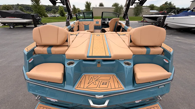 Slide: The Image of The image shows the interior of a 2027 MasterCraft XT22 boat with beige seating. - 12
