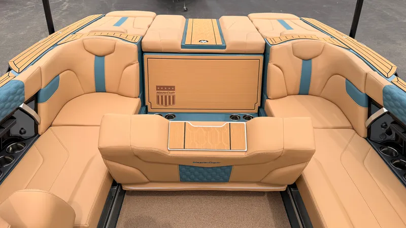 Slide: The Image of The image shows the interior of a 2027 MasterCraft XT22 with beige and blue upholstery. - 34