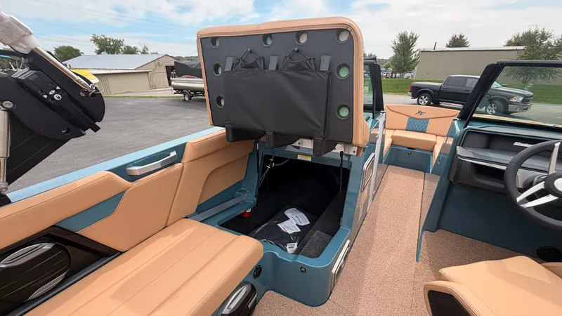 Slide: The Image of The image shows the interior of a 2027 MasterCraft XT22 boat with beige seats and blue accents. - 46