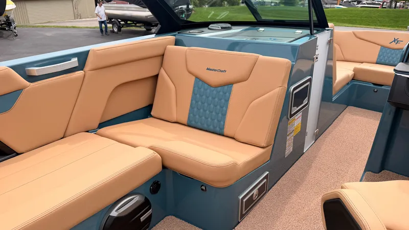 Slide: The Image of The image shows the interior of a 2027 MasterCraft XT22 boat with beige and blue seating. - 44