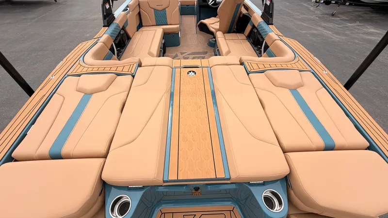 Slide: The Image of The image shows the spacious, luxurious cockpit of a 2027 MasterCraft XT22 with beige and blue upholstery. - 13