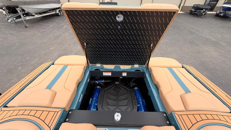 Slide: The Image of The 2027 MasterCraft XT22 features an open engine compartment with a powerful engine. - 22
