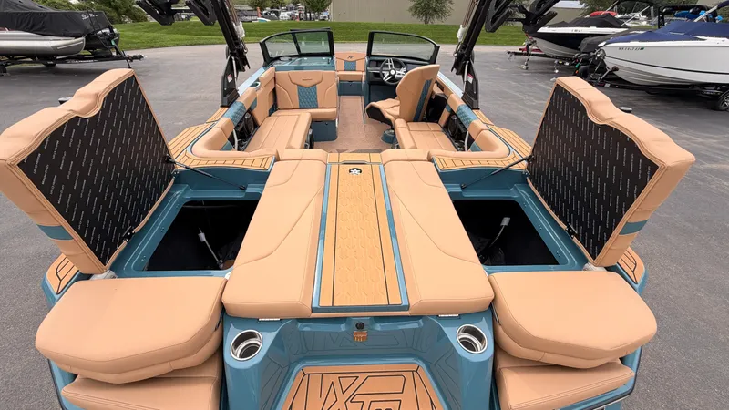 Slide: The Image of The image shows the interior of a 2027 MasterCraft XT22 boat with blue and beige seating. - 15