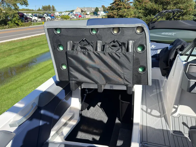Slide: The Image of The image shows the interior of a 2027 MasterCraft XT22 with a seat flipped up. - 49