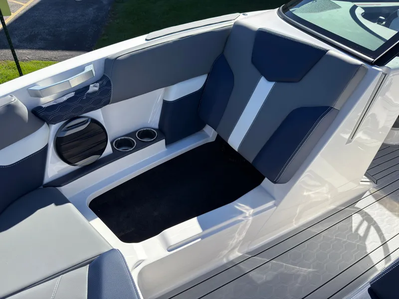 Slide: The Image of The image shows the seating area of a MasterCraft XT22 boat with blue and white upholstery. - 14