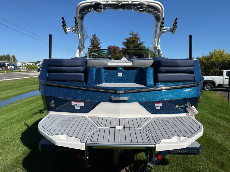 Slide: The Image of The image shows the rear of a 2027 MasterCraft XT22 boat with blue metallic paint. - 11