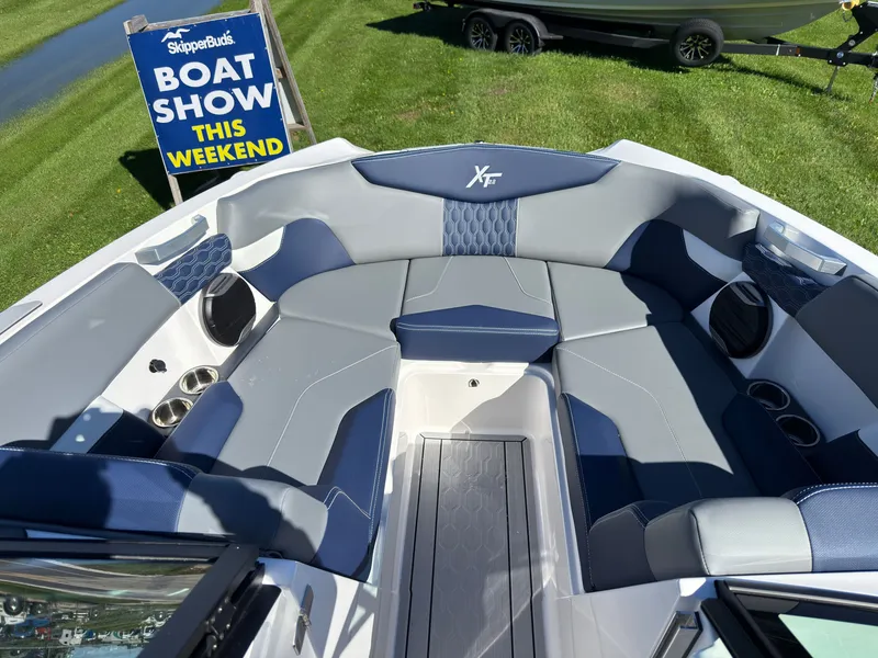 Slide: The Image of The image shows the interior of a MasterCraft XT22 boat with sleek blue and gray seating. - 20