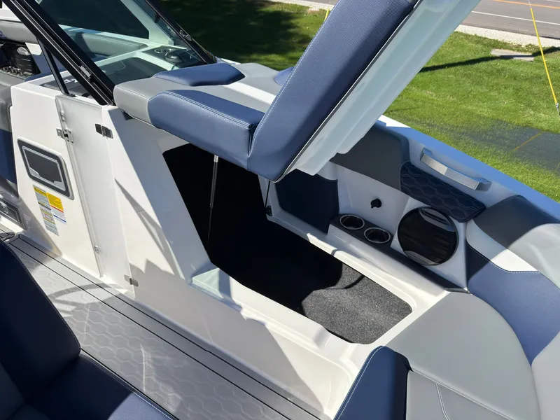 Slide: The Image of The image shows the interior of a 2027 MasterCraft XT22 boat with blue upholstery. - 18