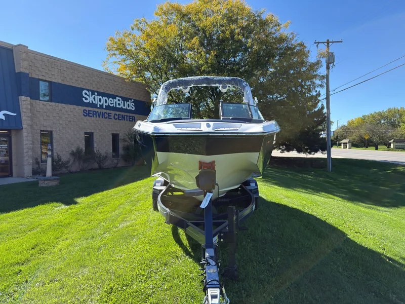 Slide: The Image of A 2027 MasterCraft XT22 boat on a trailer in front of a service center. - 3