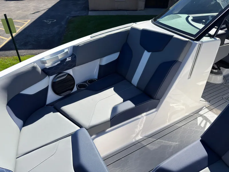 Slide: The Image of The image shows the seating area of a 2027 MasterCraft XT22 boat with blue and gray upholstery. - 15