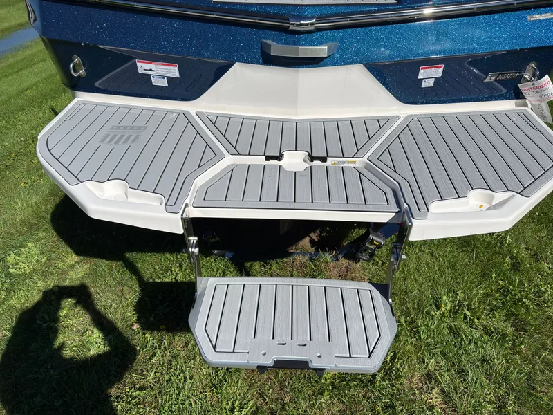 Slide: The Image of The image shows the rear of a 2027 MasterCraft XT22 with a fold-out swim platform. - 9