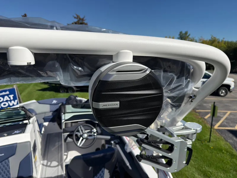 Slide: The Image of A speaker is mounted on a white roll bar of a MasterCraft XT22 boat. - 41